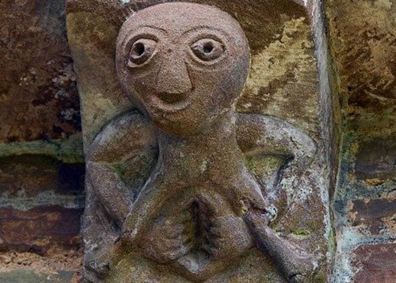 Stone medieval wall statue with open vulva. 